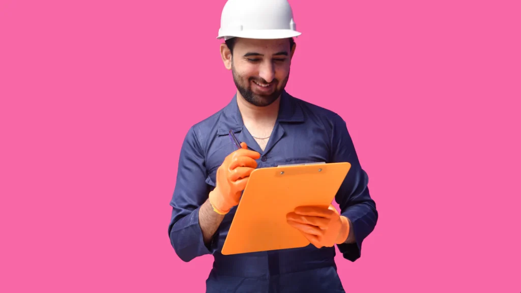 Contractor in a hard hat holding a folder of close-out paperwork